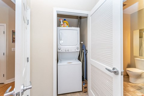 50 WB's furnished apartment showing a small laundry room with a washer and dryer in it